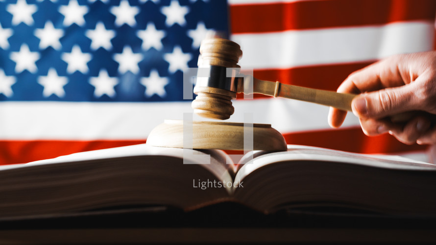U.S. Supreme Court with gavel on a book and American flag