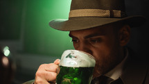 Man In Hat Drinks Green Beer