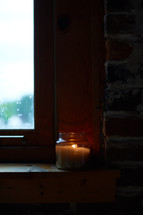 candle in a window sill 