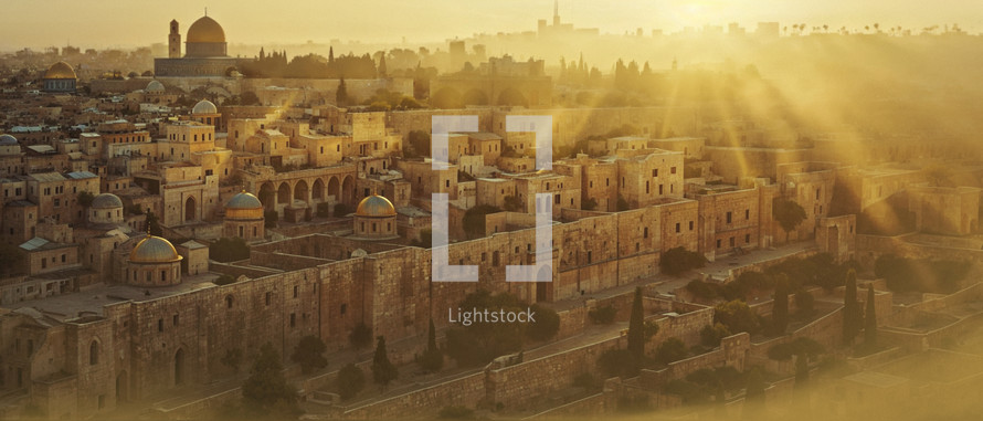 The Wall of David runs along the sides of the temple in Jerusalem. During the early morning hours as the sun rises above the horizon. 
