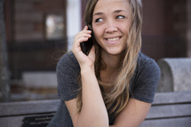a young woman talking on the phone.