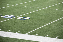lines on a football field at the 30 yard line.