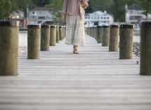 a woman walking on a dock 