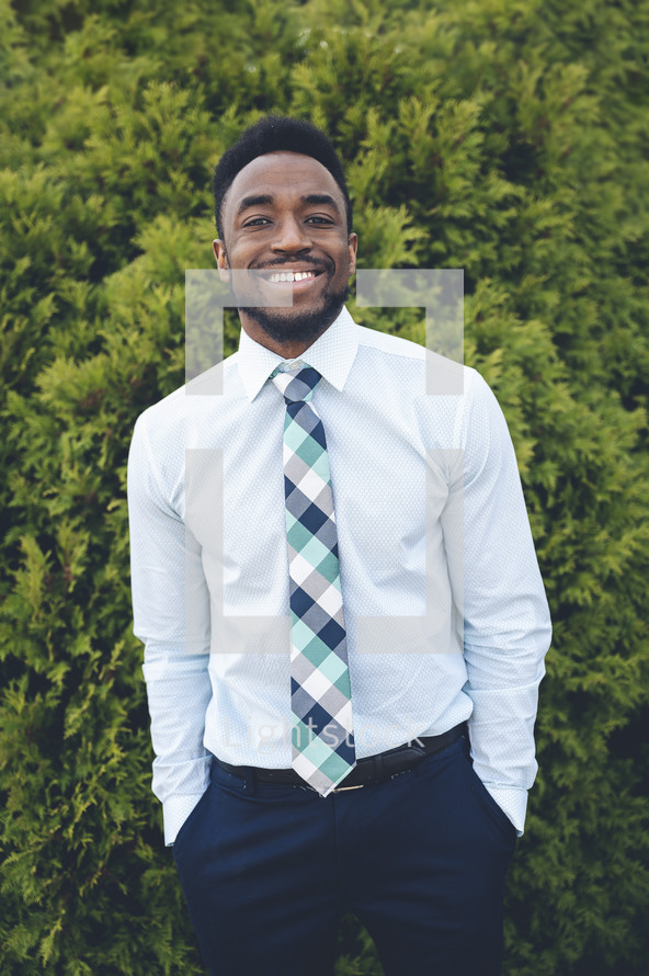 a smiling man in a tie 