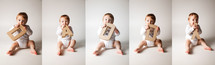 A little boy spelling out "DADDY" with cardboard letters