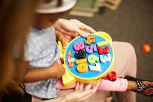 toddler girl playing with a learning puzzle