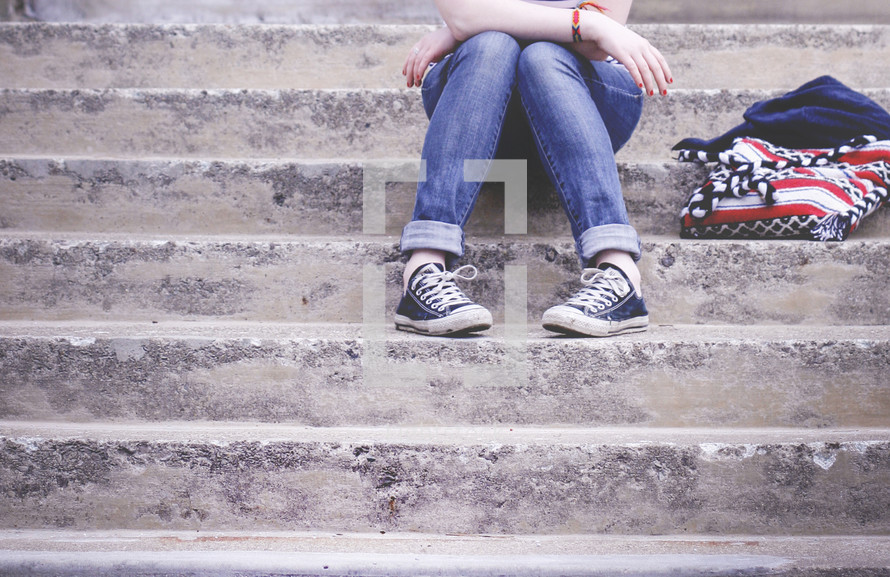 teenager waiting on steps 