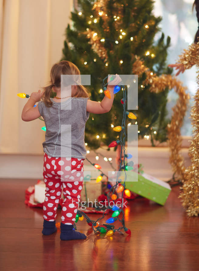 girl decorating a Christmas tree