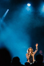 a woman in song on stage 
