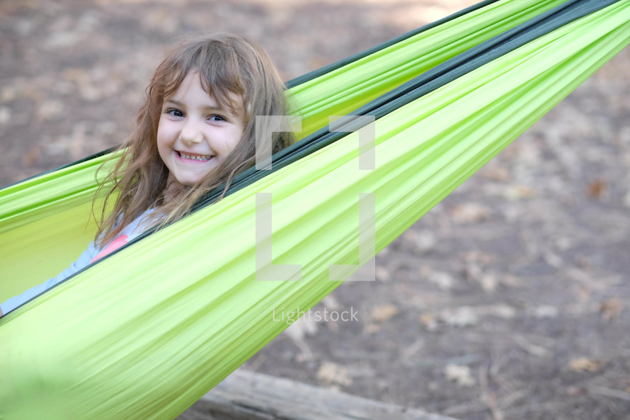 smiling girl in a hammock 