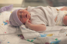 a newborn baby in a hospital bed 