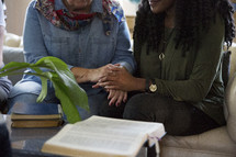 woman's group Bible study having a discussion in a living room 