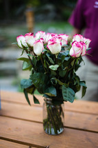 Bouquet of roses on a wooden table.