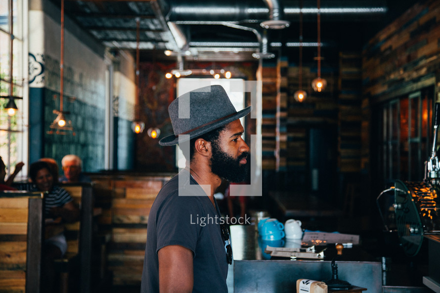 man in a restaurant in a hat 