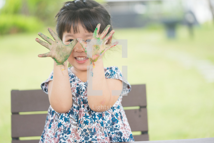 girl with paint on her hands 