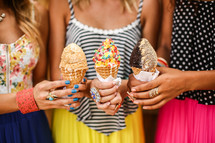 young woman holding ice cream cones 