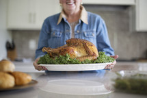 a woman holding a Thanksgiving turkey 