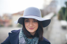 head shot of a woman in a hat, scarf, and peacoat