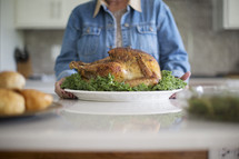 a woman holding a Thanksgiving turkey. 
