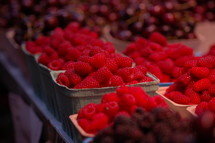 Bushels of raspberries and cherries.