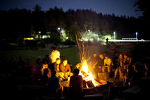 people sitting around a bonfire 