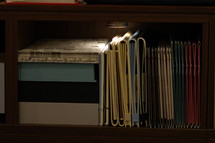 A shelf of books and binders.