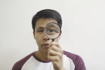 a man holding a magnifying glass 