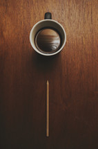looking down at a coffee mug and pencil 