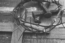 crown of thorns, nails, and cross in black and white 