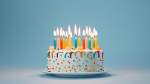 Colorful candles on a birthday cake with sprinkles. 