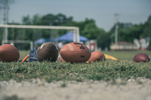 footballs on a practice field 