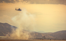 helicopter kicking up dust 