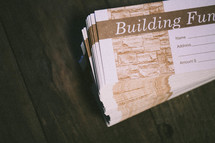 Building fund envelopes stacked