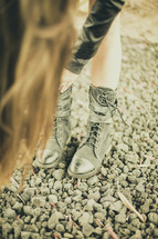 girl fastening the a buckle on her boots