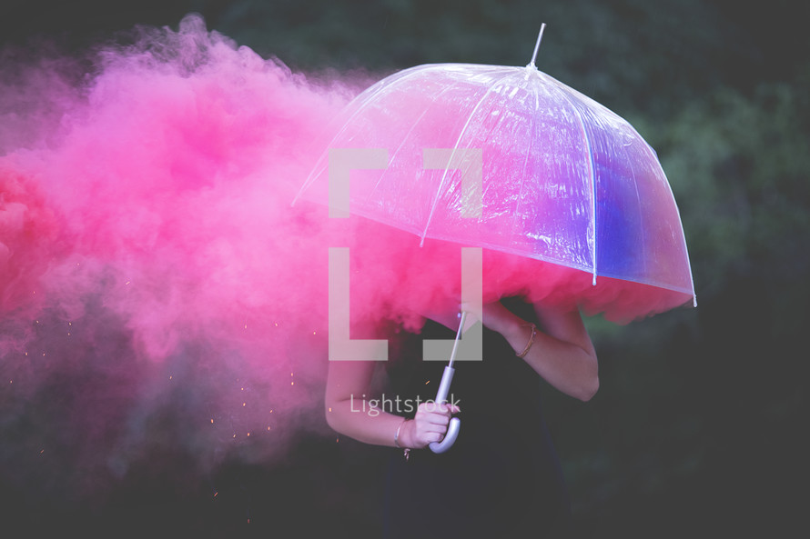 pink smoke and woman under an umbrella 