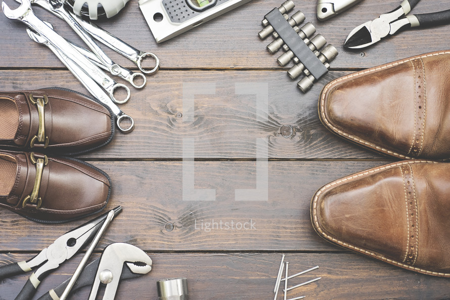 dress shoes and tools on wood 