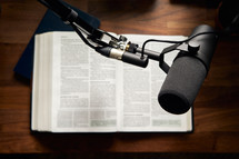 microphone over the pages of an opened Bible 