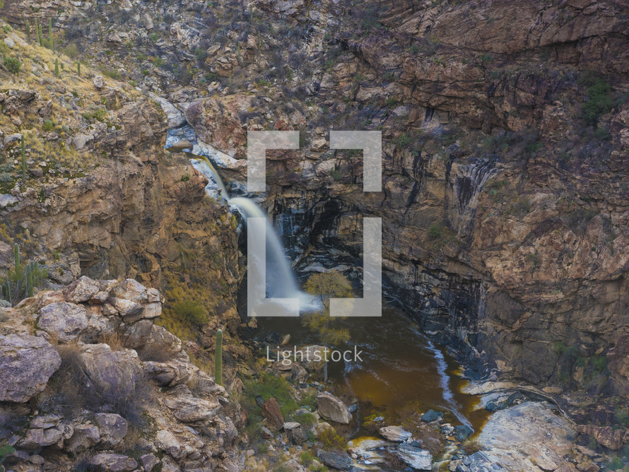 A large waterfall in a desert oasis