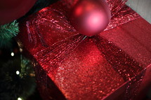 a shiny red gift under the tree