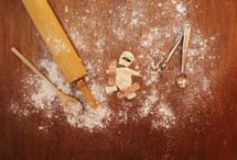 A broken Halloween mummy cookie mended with band-aids on a cooking area with cooking utensils.
