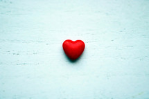 red heart on a white wood background 