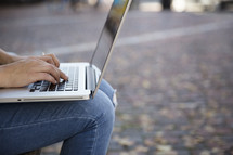woman sitting with a laptop on her lap 