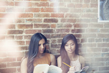 Two young women studying together.