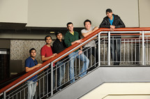 group of diverse male students standing on stairs 