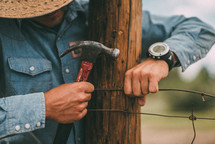 a man installing fence wire 