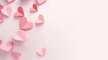 Pink background with pink paper hearts. 