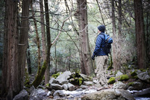 a man with a backpack hiking in the woods 