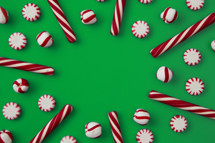 candy canes and mints on green 