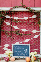 A welcome sign for a wedding escort card table peaches flowers