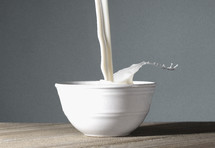 A Bowl of MIlk Being Poured and Splashing Out